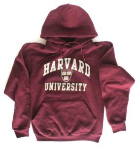 A maroon harvard university hoodie with the hood up.