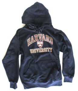 A harvard university hoodie is shown on the ground.