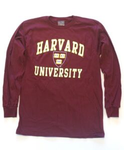 A maroon long sleeve shirt with the harvard university logo on it.